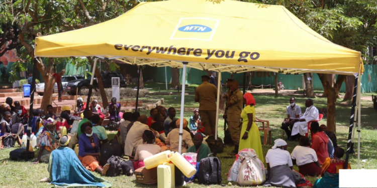 Stranded pilgrims gathered in a tent