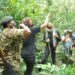 L-R: UWA ranger, UTB CEO Lilly Ajarova (2nd left), Terrence Howard (centre) and other officials tracking chimpanzees in Kibale National Park on Saturday.