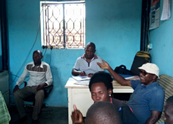 Arthur Mujuni with complainants at Gerenge police post