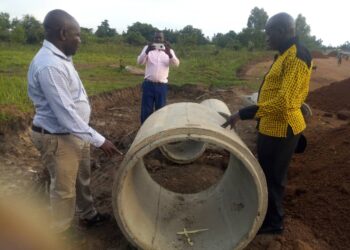 RDC Adiama inspecting the substandard culverts which were being used on Okodi Acur Road