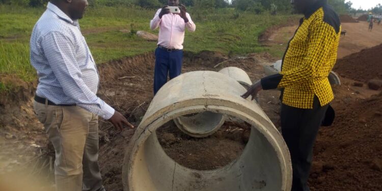 RDC Adiama inspecting the substandard culverts which were being used on Okodi Acur Road