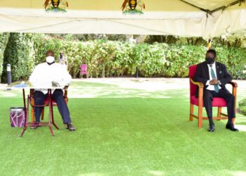 President Yoweri Museveni (left) who is also the Chairman of the National Resistance Movement (NRM) and the  Democratic Party (DP) President Norbert Mao (right) having a moment together after signing  the Cooperation agreement between the NRM and DP at the State House Entebbe on 20th July 2022. Photo by PPU/Tony Rujuta.