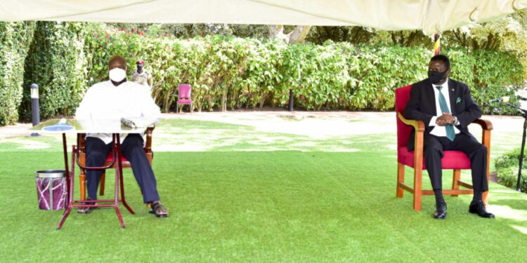 President Yoweri Museveni (left) who is also the Chairman of the National Resistance Movement (NRM) and the  Democratic Party (DP) President Norbert Mao (right) having a moment together after signing  the Cooperation agreement between the NRM and DP at the State House Entebbe on 20th July 2022. Photo by PPU/Tony Rujuta.