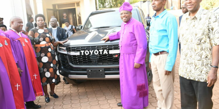 Bishop of Diocese of Kigezi Gaddie Akanjuna (3rd Right) receiving the new vehicle on July 23 in Kabale town.