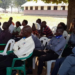 Headteacher, Ekunyu seated with some of his staff in th meeting with district officials