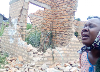 Keturah Ategeka crying near her demolished house