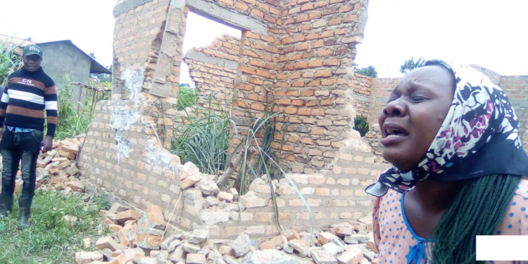 Keturah Ategeka crying near her demolished house