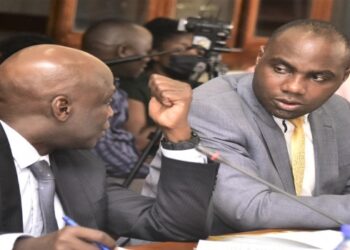 Hon. Henry Musasizi (R) was put to task to explain government's interest in buying shares in Roko Construction Ltd