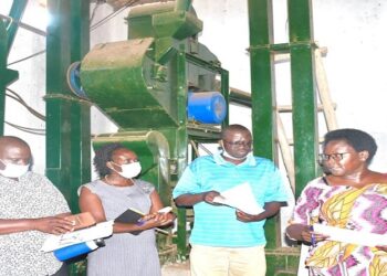 MPs on the committee in one of the coffee factories in Kalungu