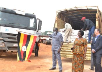 The Minister for Relief, Disaster Preparedness and Refugees, Mr Hilary Onek (left) and Napak District Woman MP Faith Nakut flag off relief food to Karamoja at Office of the Prime Minister stores in Namanve, Wakiso District on July 19, 2022. Courtesy Photo