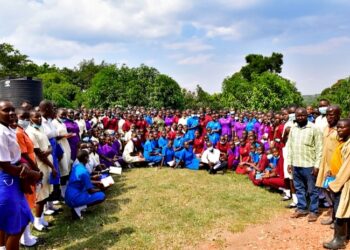 Students from Tororo Girls School pose for a photo after touring Kawumu Presidential Farm in Luwero district on Friday. (Standing R) are staff of the farm