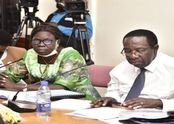 The Chair of the Committee, Hon. Keefa Kiwanuka peruses documents during the meeting