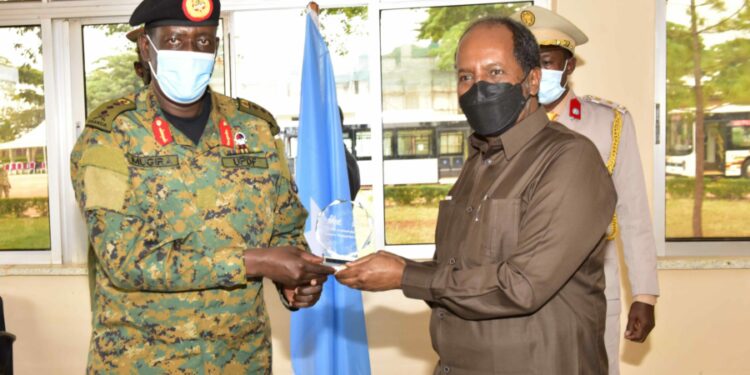 The President of the Federal Republic of Somalia H.E. Hassan Sheikh Mohamud receiving a souvenir from National Enterprise Cooperation (NEC) Managing Director Lt. Gen. James Mugira during the official visit at Luwero Defence Industries Nakasongola on 9th August 2022. Photo by PPU/Tony Rujuta.