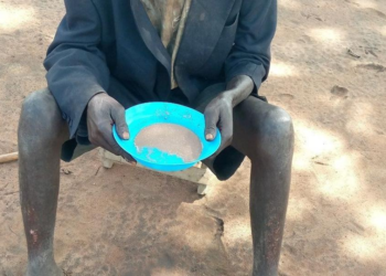 84 year old Okwir eating soup at his friend's home