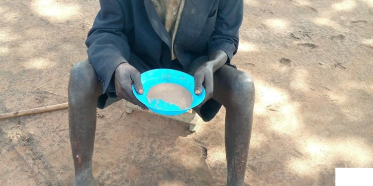 84 year old Okwir eating soup at his friend's home