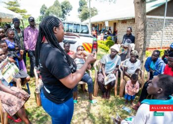 A female youth demostrates how to use a condom in Kabeywa village Kapchorwa district