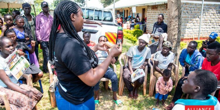 A female youth demostrates how to use a condom in Kabeywa village Kapchorwa district