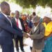 Kagadi Deputy RDC Benjamin Tumusiime with some of the area Residents