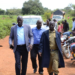 Leaders with police officer along the road where traders lost lives