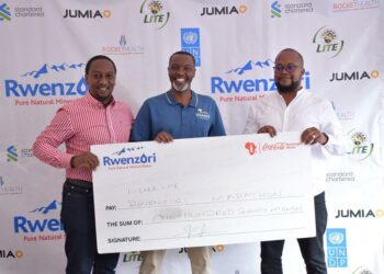 L-R- Kirunda Magoola Public Affairs and Communication Director, Newton Lee Ogong Channel and Trade Marketing Manager at Coca- Cola Beverages Uganda with Equator Hikes Director, Amos Wekesa during the launch today