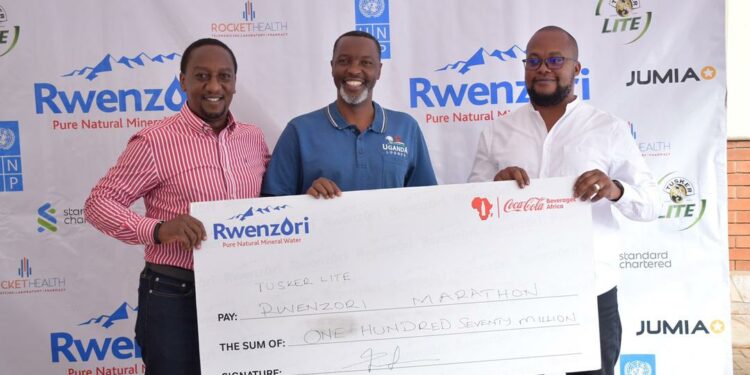 L-R- Kirunda Magoola Public Affairs and Communication Director, Newton Lee Ogong Channel and Trade Marketing Manager at Coca- Cola Beverages Uganda with Equator Hikes Director, Amos Wekesa during the launch today