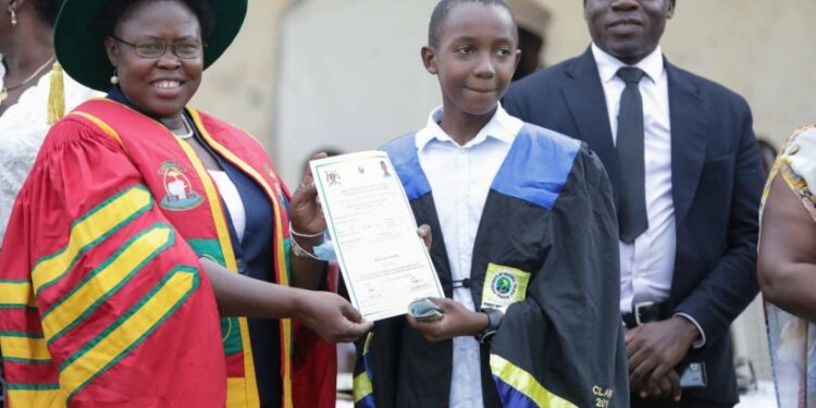 Minister Kaducu handing over a certificate to one of the successful youth under the DIT program