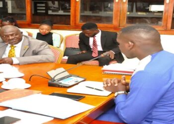 Gen Katumba Wamala (in yellow tie) before the Committee chaired by Hon. Ssenyonyi (R)