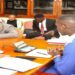 Gen Katumba Wamala (in yellow tie) before the Committee chaired by Hon. Ssenyonyi (R)