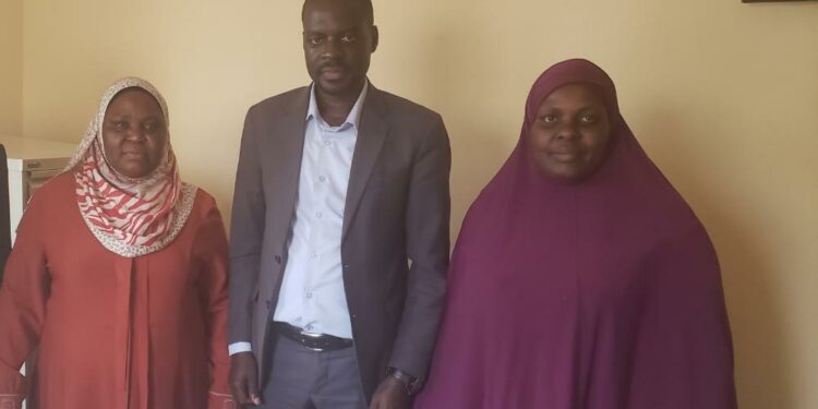 Trevor Solomon Baleke and Wante Muslim SS Headmistress Khadija  Nakimwero (R) pose for a photo in the latter's office after addressing the parents