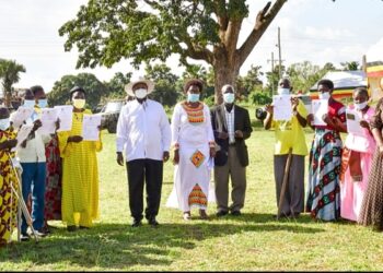 President Museveni poses for a photo with some of the beneficiaries who received   certificates of titles of customary land ownership in Apac on Thursday. (R) are Hon Nabakooba and Namuganza