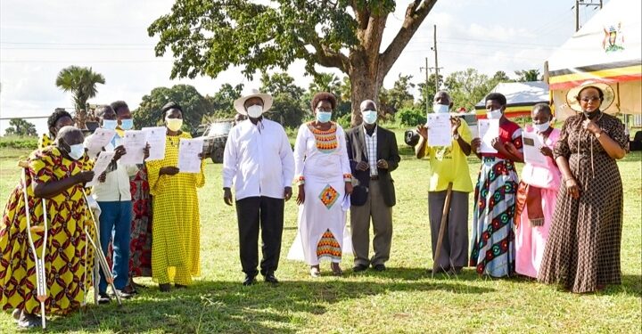 President Museveni poses for a photo with some of the beneficiaries who received   certificates of titles of customary land ownership in Apac on Thursday. (R) are Hon Nabakooba and Namuganza