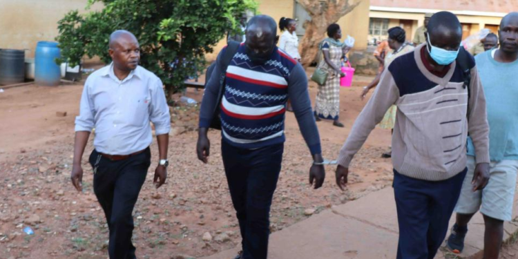 Ogwang and Otike at Lira central police station