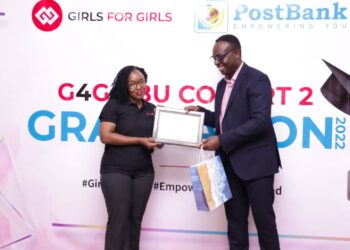 Post Bank Uganda CEO Julius Kakeeto hands over a special plaque and gift to Esther Bwaku for her outstanding role the Girls for Girls second cohort Leader and Chief Mobiliser in the Bank.