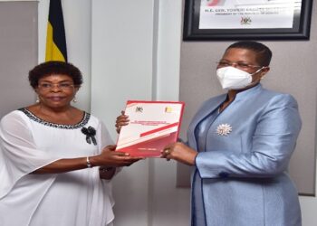 Speaker Among (R) receives the report from IGG Beti Kamya at Parliament