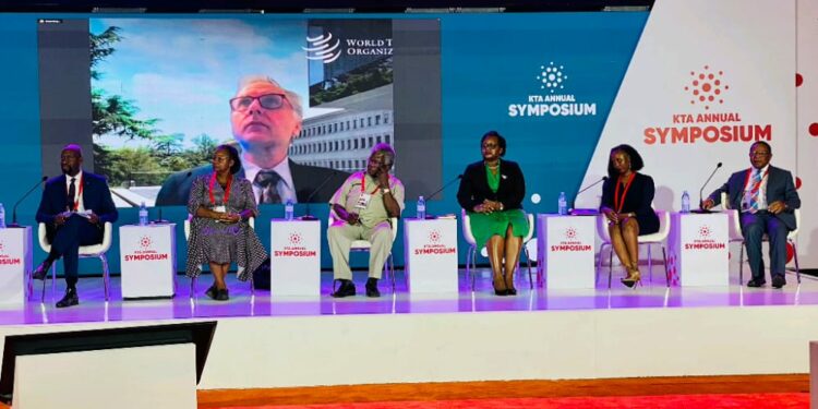 From left to right: Morrison Rwakakamba (Chairman Uganda Investment Authority), Antony Taubman on the screen (Director of Intellectual Property, WTO) , Mercy Kainobwisho (ED, URSB), Prof. Sandy Stevens Tickodri-Togboa (Chairperson, Kiira Motors Corporation), Dorothy Kisaka, (ED, KCCA) Eng.  Dorothy Okello (Dean school of Engineering, Makerere University) and Prof.  Ezra Suruma (Chancellor, Makerere University) during the 5th annual KTA Symposium at Speke Resort Munyonyo.