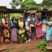 The State House Political desk's Princess Pauline Nassolo and Flora Kabibi in a group photo with market vendors of Nakwero market in Nakwero zone B village, Kimanyi parish, Kiira Municipality, Wakiso District on 8th November 2022. Photo by PPU/ Tony Rujuta.