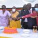 Hon. Babalanda joined by other government officials to cut a cake during the official opening of Bushenyi RDC Office