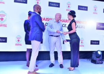Mr.Stober handing over a donation from the Simplifi Networks to Ms. Veronika Cejpkova, Whisper’s Founder & CEO, during the fundraising dinner at Protea Hotel Kampala in October