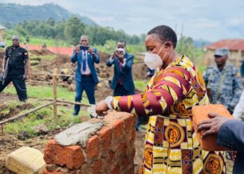 Minister Babalanda laying a foundation for the construction of Bufumbira SDA Secondary School A'level classroom block