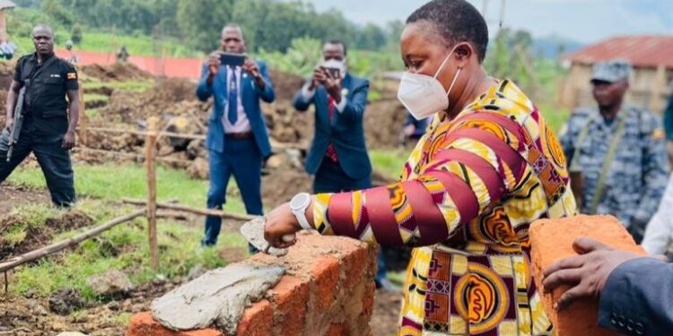 Minister Babalanda laying a foundation for the construction of Bufumbira SDA Secondary School A'level classroom block