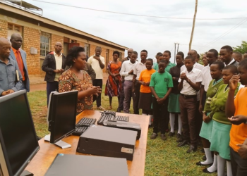 Hon. Mary Begumisa while handing over computers to students and teachers of Mateete seed school secondary