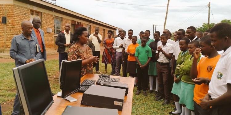 Hon. Mary Begumisa while handing over computers to students and teachers of Mateete seed school secondary