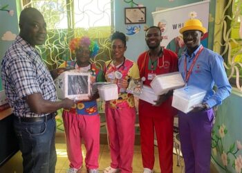 Mr. Lubyayi handing over pediatric equipment to Whisper's staff