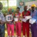 Mr. Lubyayi handing over pediatric equipment to Whisper's staff