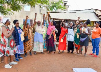 The State House Political desk Princess Pauline Nassolo (left) and Flora Kabibi (second left) in a group photo with very excited women from Bukoloto market while talking to them on how to embrace government programs in Kayunga district on 9th December 2022. Photo by PPU/ Tony Rujuta.