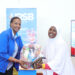 Freda Bwiizi, Director Research & Planning hands over a gift hamper to Faridah Asiimwe of UWEAL during the closure of URSB's Customer Engagement Week.