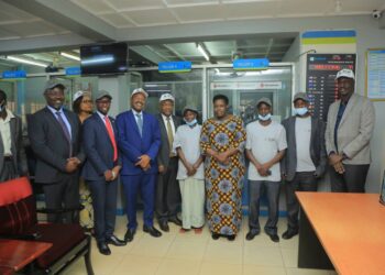 Vice President Jessica Alupo (centre) with Post Bank ED Andrew Kabeera second left, Ministers Amos Lugolobi and Raphael Magyezi plus some of the PDM beneficiaries and Coordinator Dennis Galabuzi extreme right after the first recipeints got their PDM cash at Post Bank Kayunga Branch