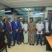 Vice President Jessica Alupo (centre) with Post Bank ED Andrew Kabeera second left, Ministers Amos Lugolobi and Raphael Magyezi plus some of the PDM beneficiaries and Coordinator Dennis Galabuzi extreme right after the first recipeints got their PDM cash at Post Bank Kayunga Branch