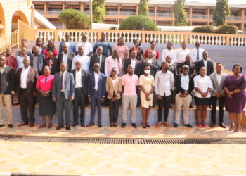 URSB Deputy Registrar General, Alex Anganya (2nd L) in a group picture with Tier IV Non Deposit Taking Institutions Representatives at Hotel Africana in Kampala.