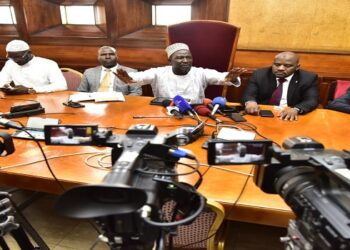 Hon. Basalirwa (C) flanked by his colleagues addresses the media on the arrests